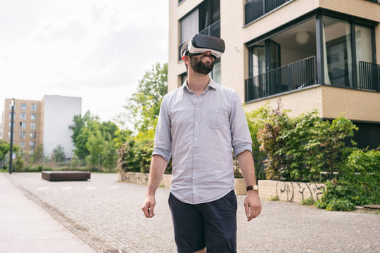Man wearing Virtual Reality Glasses outdoors