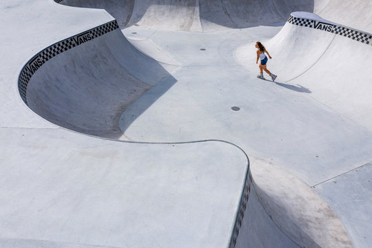 Young woman inline skating in skatepark