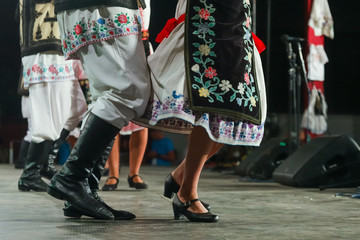 Close up of legs of young Romanian female and male dancers in traditional folkloric costume....