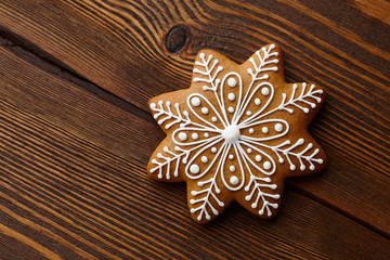 Christmas gingerbread snowflake on wooden texture