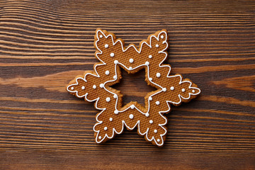 Christmas gingerbread snowflake on wooden texture