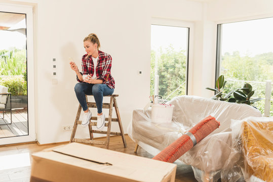 Woman moving into new home having a coffee break