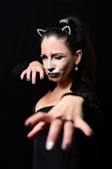 Fototapeta premium Playful predatory lady with cat makeup. Beauty model portrait in studio