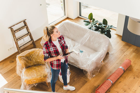 Woman moving into new home using tablet