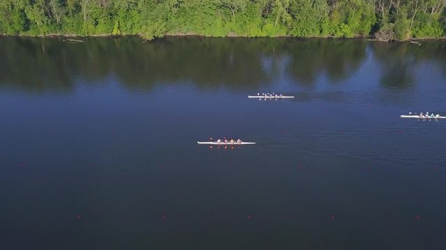 Aerial footage of rowing regatta on Grand River, Michigan. Drone moves upward and backward, revealing horizon and surrounding area.