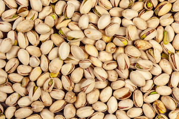 Background of laid flat pistachio nuts