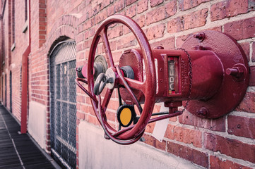 Closeup of a hydrant stuck in a brick wall