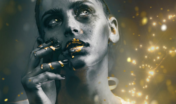 Gold Paint smudges drips from woman face, lips and hand, lipgloss   dripping from sexy lips, golden liquid drops on beautiful model girl's   mouth, gold metallic skin make-up