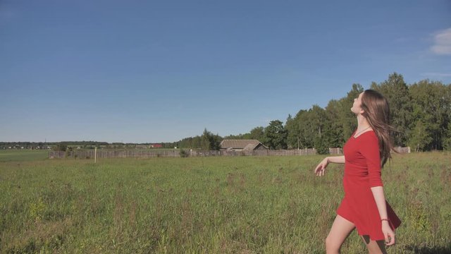 A girl launches a toy paralon airplane into the sky.