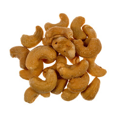 Roasted and salted cashews on a white background.