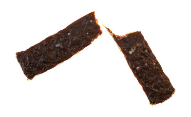 Single broken piece of venison jerky on a white background