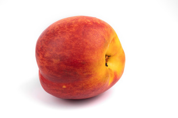 Side view on one isolated orange fruit nectarine on white background