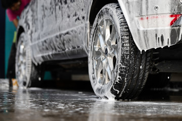 Manual car wash with pressurized water in car wash shop service.