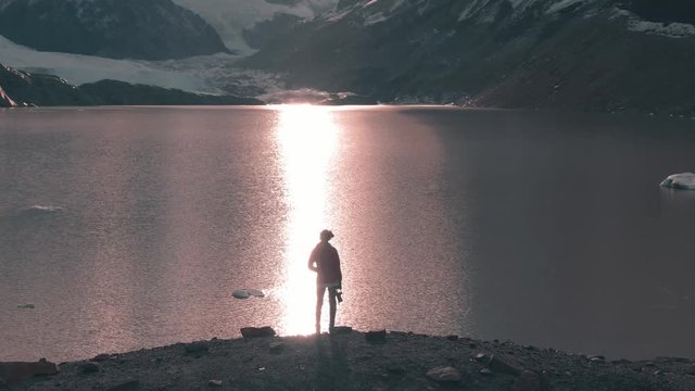 Aerial panoramic footage of young girl hiking the Cerro Torre trek, showcasing the beautiful Patagonia mountain landscape