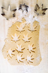 preparing some cookies with marijuana without tbc and shape of the leaf of marijuana, top view, flatlay composition