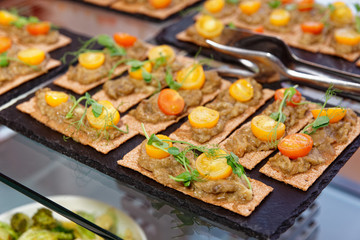 Crisp bran breads with eggplant mash and cherry tomatoes