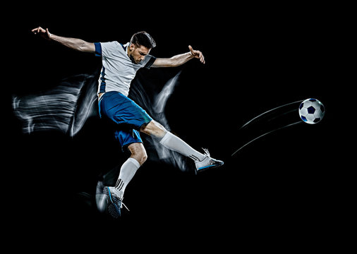 one caucasian soccer player man isolated on black background with light painting speed effect