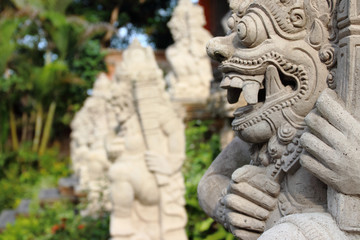 Fototapeta na wymiar Detail of statues and sculptures placed in the garden outside Ubud Palace Puri Saren Agung, home of the Ubud royal family and one of the most visited spots of the whole city.