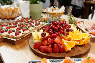 Fruits, berries and dessert on restaurant table