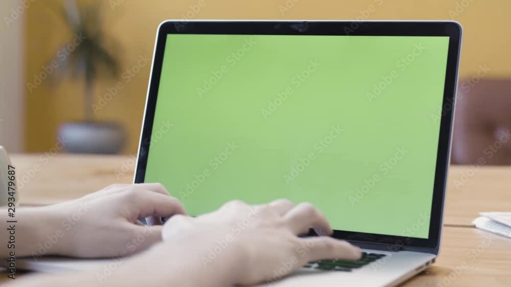 Poster a man is working at home and using laptop with green screen, communication and business concept. sto