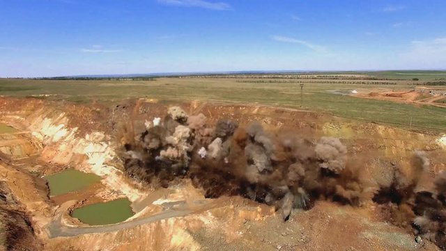 Aerial view of an industrial explosion in an alumina quarry.