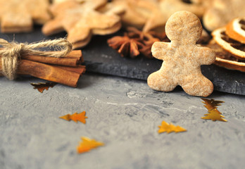 Christmas cookies, cinnamon, dried oranges on wooden background.