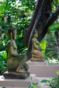 statue of woman in tropical garden