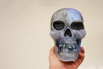 Halloween decoration glowing skull in the hand. Empty space for text input. Halloween concept