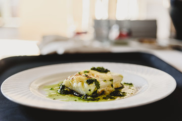 Exquisite dish of baked fish elegantly plated.