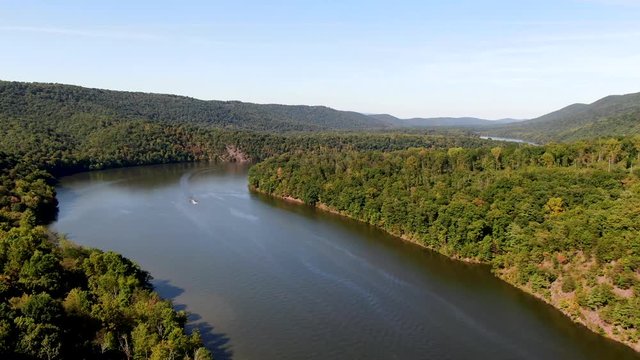 Aerial view of Raystown lake with a motorboat in the middle in Pennsylvania.