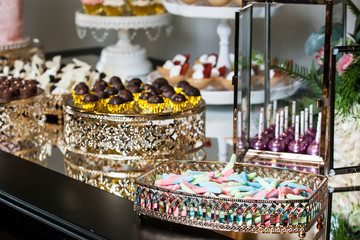 Party decorations; Candy table, table with various sweets and cakes.