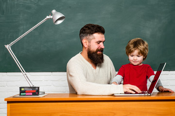Teacher helping young boy with lesson. Parent Teacher. Dad son are concentrated on the problem. Education and learning people concept - little student boy and Teacher.