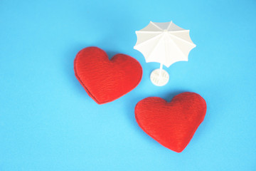 Insurance Health concept - White umbrella on red heart healthcare on blue background