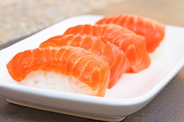 Close up of fresh japanese salmon sushi in white dish..