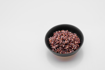 Cooked Sorghum (also known as sorgo) in a back bowl, isolated