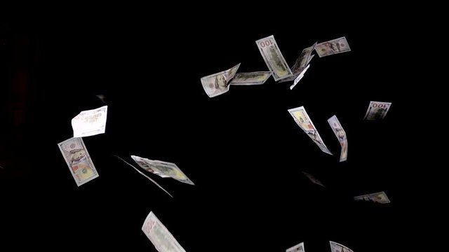 Hundred dollar bills falling down. US currency $100 cash raining down on black background. Economic success and banking abstract concept.
