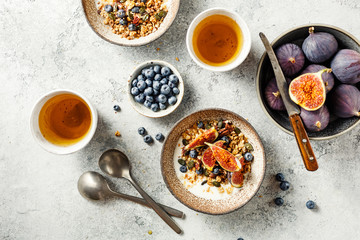 Delicious and healthy Breakfast with homemade granola, fruits and berries.