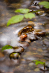 A long exposure of water flowing around rocks in a creek