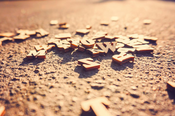 Letters fall on the asphalt, tinted photo of the English alphabe