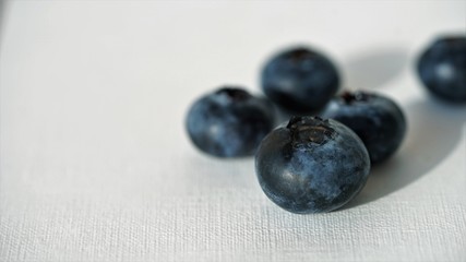 close up view on fresh blueberries on white background