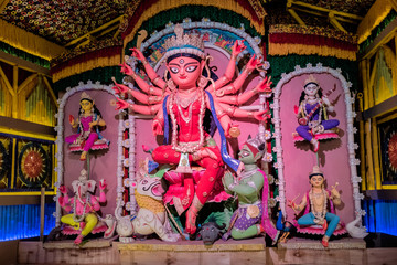 Fototapeta na wymiar Idol of Goddess Devi Durga at a decorated puja pandal in Kolkata, West Bengal, India. Durga Puja is a popular and major religious festival of Hinduism that is celebrated throughout the world.