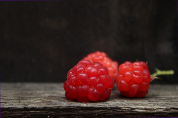 Raspberries on a dark wooden background