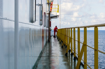 An unidentifiable offshore worker onboard a construction barge at oil field