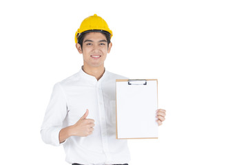 Asian handsome businessman wearing a yellow safety helmet holding and showing a thumb up a clipboard in his hand close up, isolated on white background white copy space.