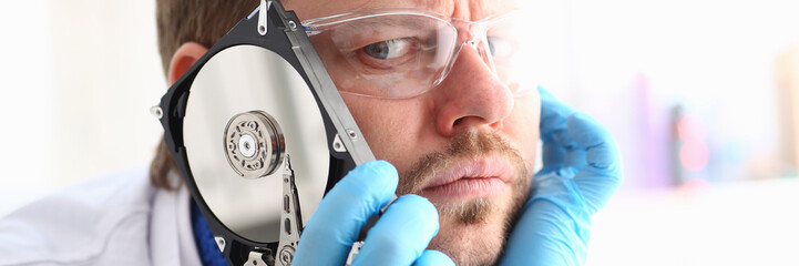 Repairman attached the hard drive of the computer to his ear. Listens to knock and crack reveals...