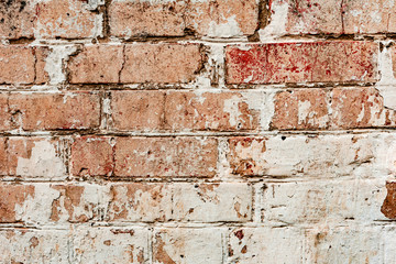 Texture of a brick wall with cracks and scratches which can be used as a background