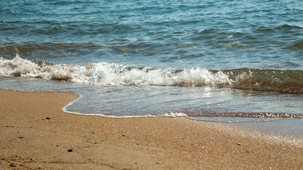sandy beach and blue sea wave. Beautiful natural background. Tourism and travel.