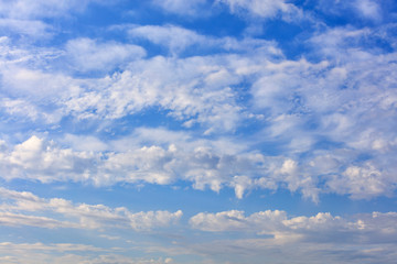 White lush clouds float in the bright saturated blue sky.