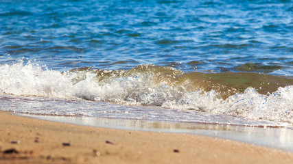 sandy beach and blue sea wave. Beautiful natural background. Tourism and travel.
