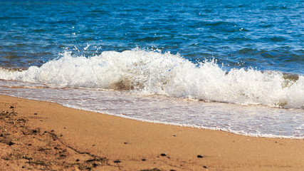 sandy beach and blue sea wave. Beautiful natural background. Tourism and travel.